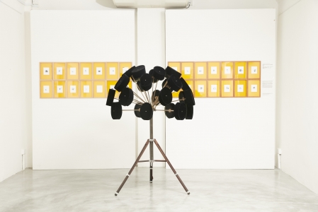 Boedi Widjaja, <i>Imaginary Homeland: 放下武器跟我走 (LAY DOWN YOUR WEAPON, FOLLOW ME)</i>, 2016, 28 pecis (traditional Indonesian hats), brass, chrome, foam, vintage camera tripod; and 28 peci pinhole negatives on Ilford paper in individual frames, 55 x 66 in. (140 x 168 cm)